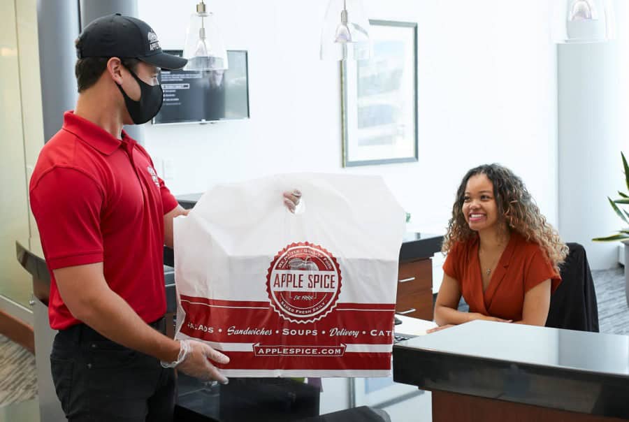 delivery-900×604 apple spice employee delivering food to office receptionist