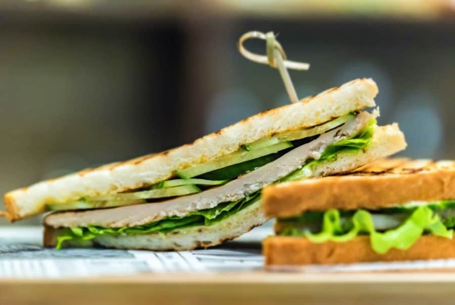Delicious grilled sandwiches with lettuce close Close up two tasty grilled sanwiches in restaurant