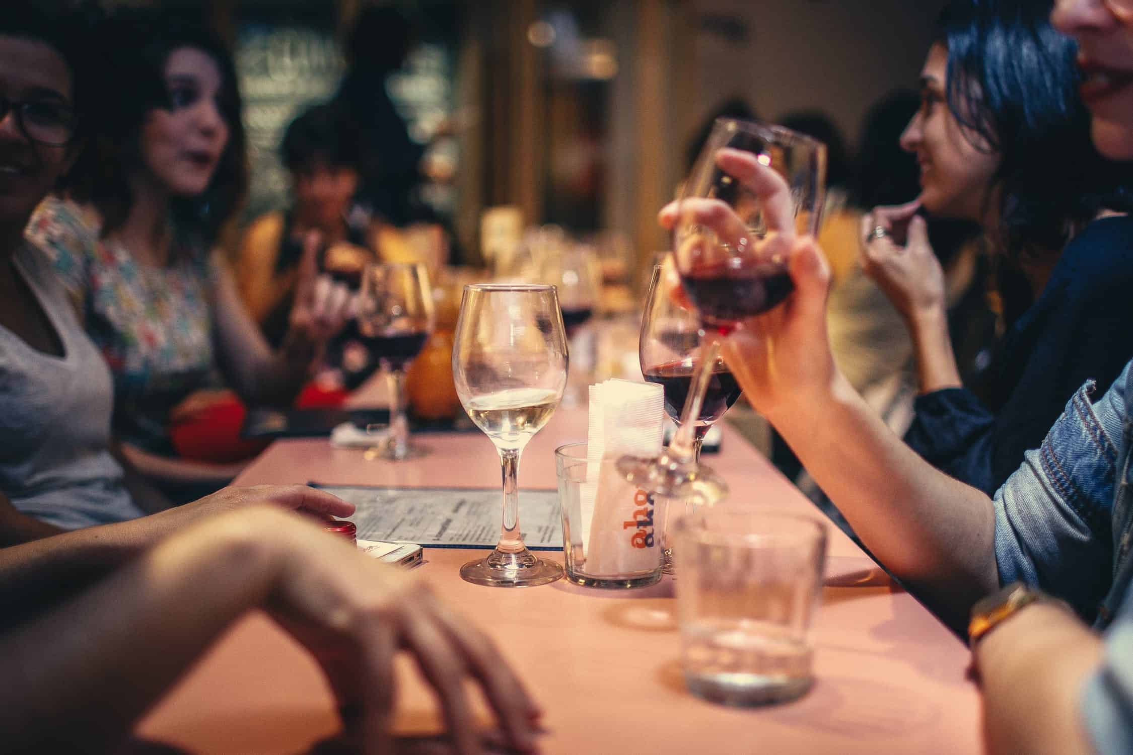 Apple Spice Dining Experience people sitting at table drinking wine